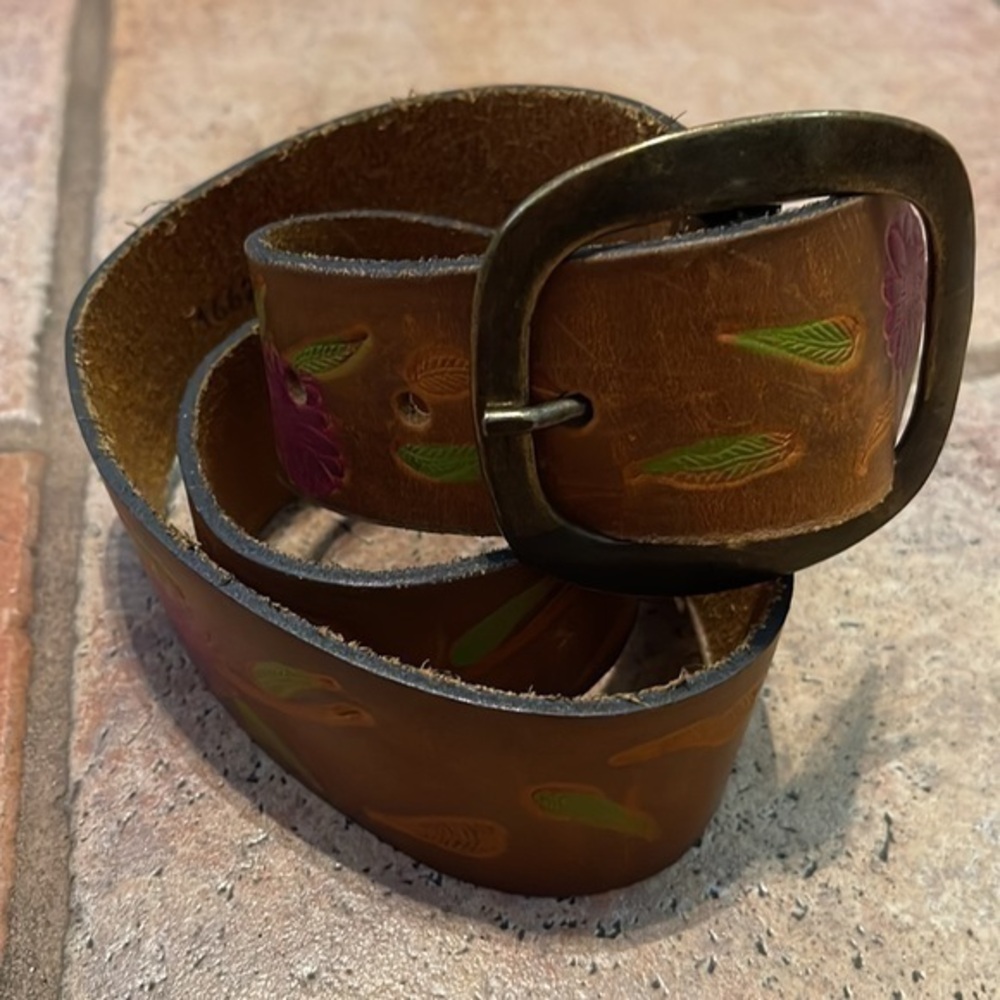 Ginuwine, leather tooled and painted belt with a brass buckle